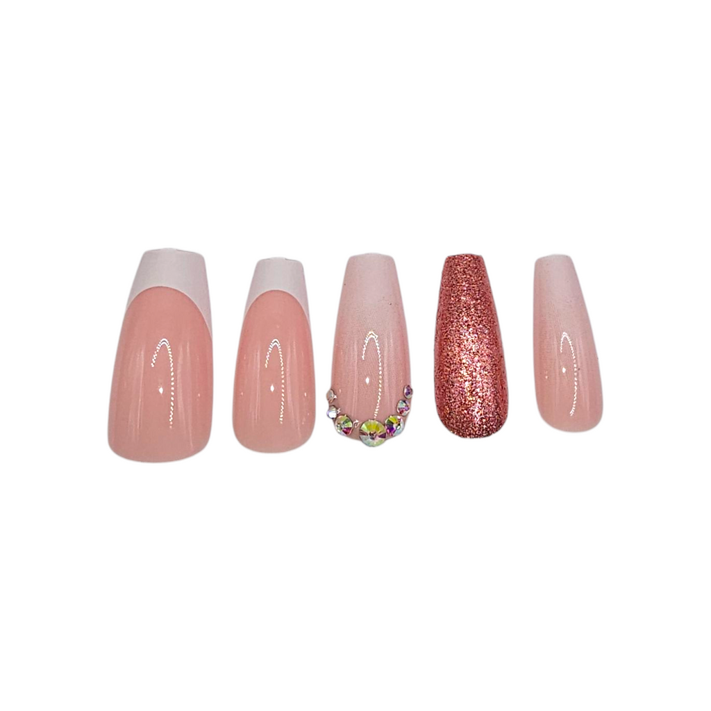 Close-up of Brunch Babes press-ons – pink base, white tips, rose gold glitter accent & rhinestone crown – Rodeo & Wilshire Beauty