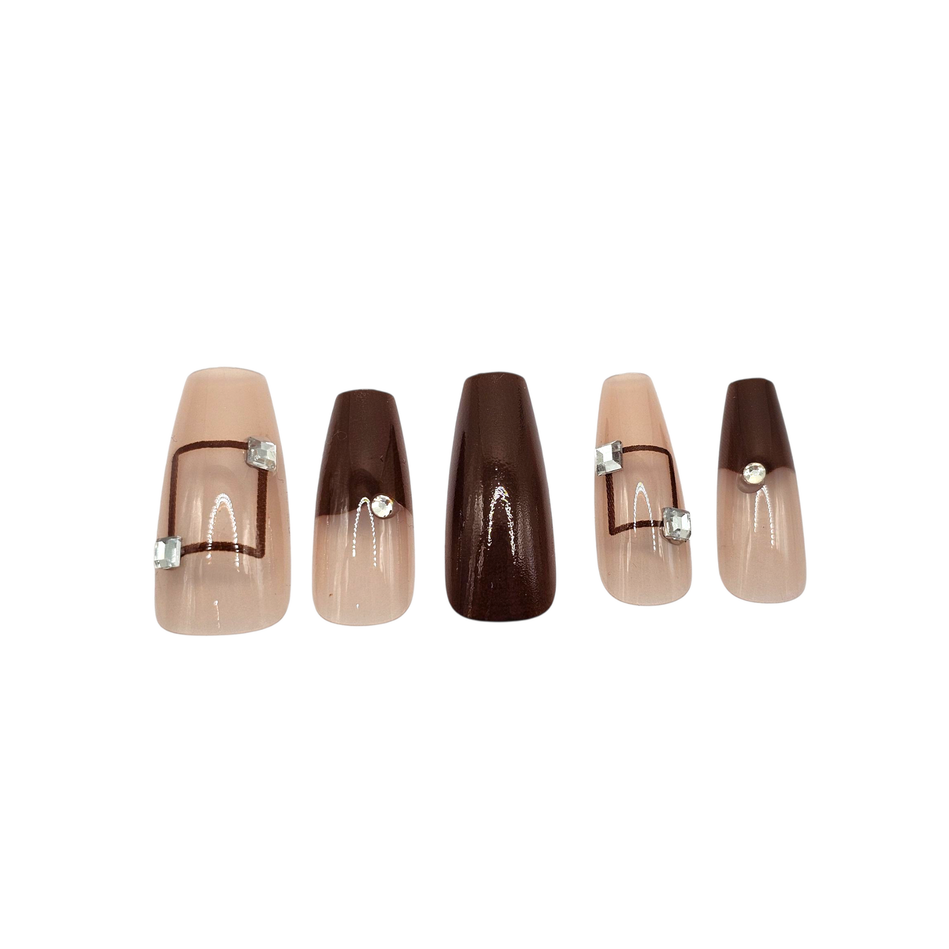 Close-up of Espresso Deco luxury press-ons – geometric line art and crystals – medium coffin shape