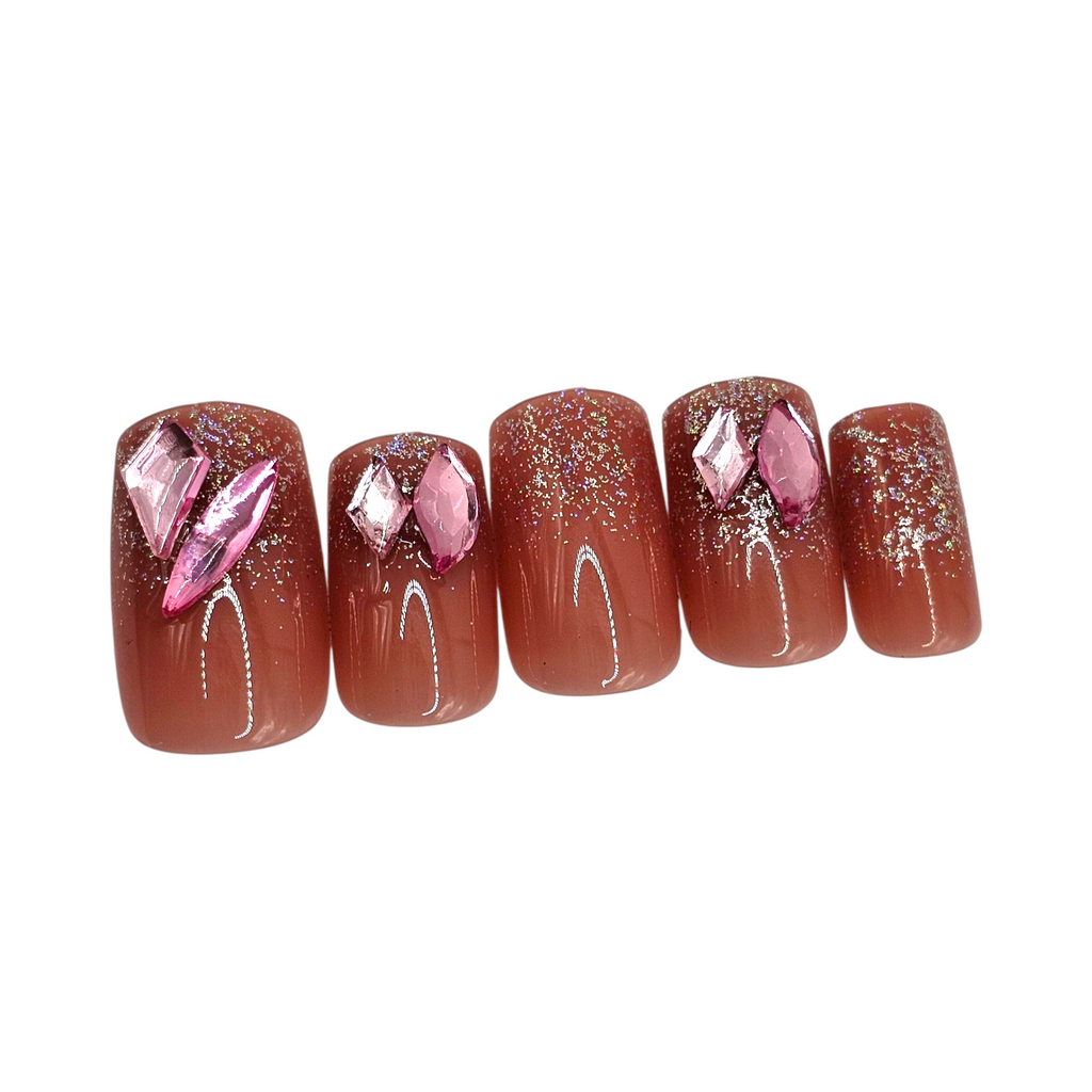 Side view of Flirtini press-on nails — luxury mauve pink short square nails with sparkle accent.