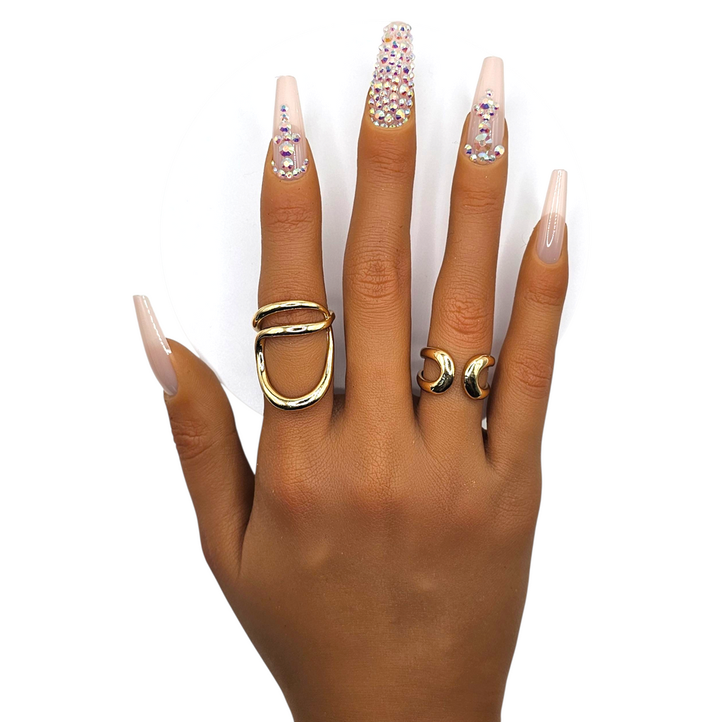 Heiress press-on nails front view — nude coffin shape with rhinestone accents.