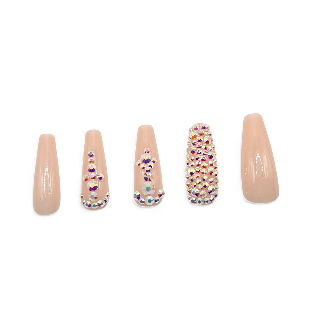 Side view of Heiress press-on nails — luxury nude coffin nails with sparkling rhinestones.