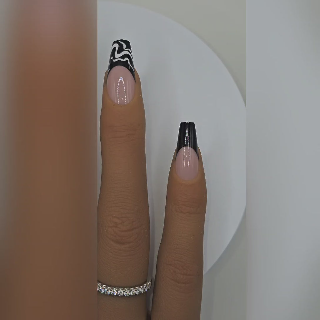 Application video showing Noir Canvas black & white abstract swirl French tip press-on nails – modern art nail styling – Rodeo & Wilshire Beauty