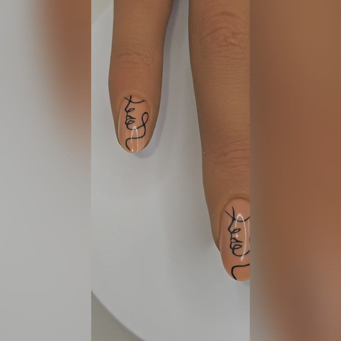 Picasso Baby press-on nails styled — modern abstract face design for chic nail art lovers