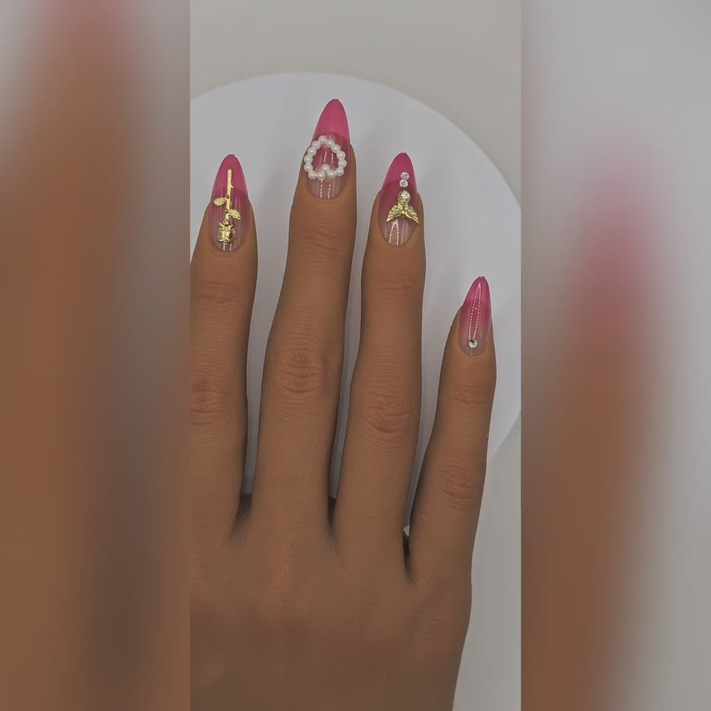 Application video showing XOXO pink ombré almond press-on nails with charms, pearls & rhinestones – Date Night styling – Rodeo & Wilshire Beauty