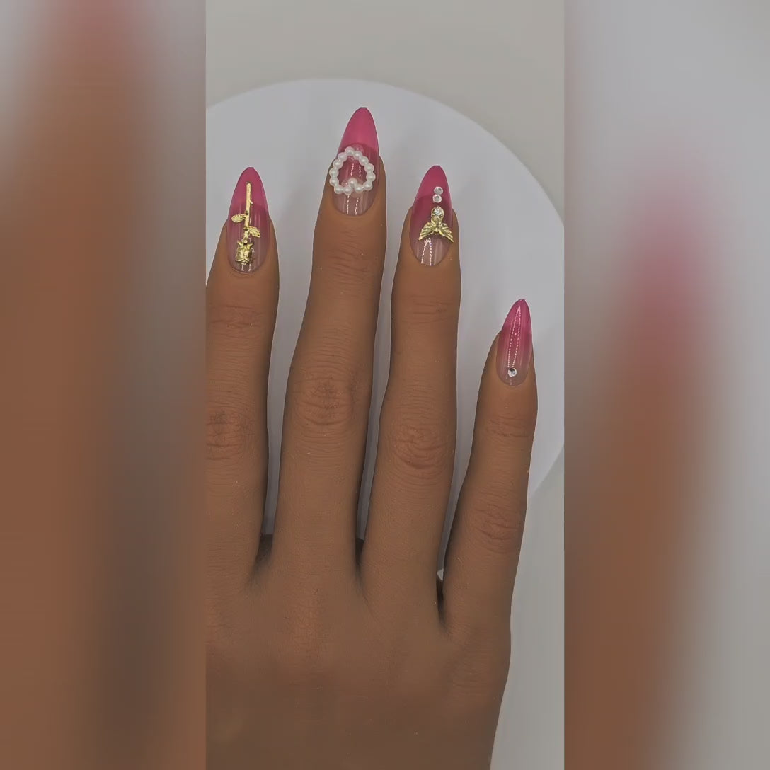 Application video showing XOXO pink ombré almond press-on nails with charms, pearls & rhinestones – Date Night styling – Rodeo & Wilshire Beauty