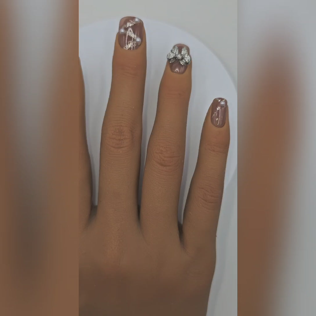 Application video showing Tea & Tennis bow & pearl nude press-on nails – garden party styling – Rodeo & Wilshire Beauty